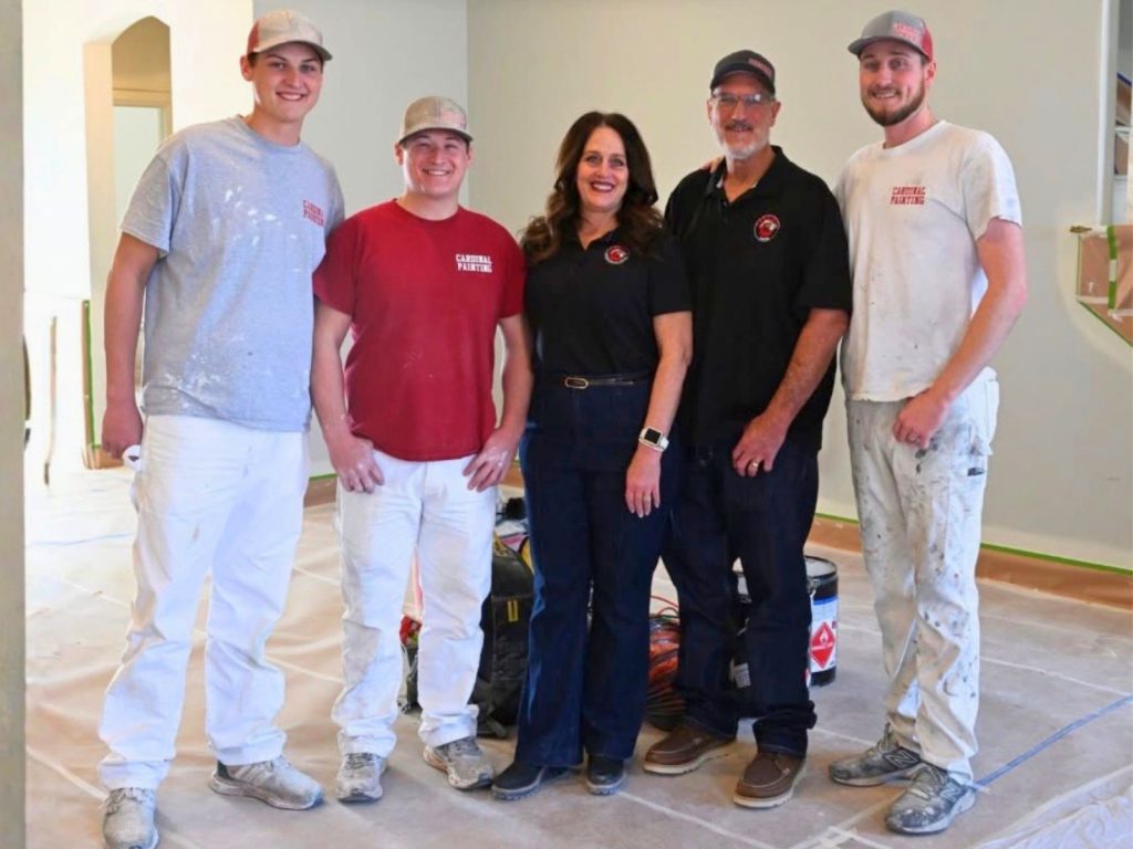 Cardinal Painting team members standing together inside a residential home
