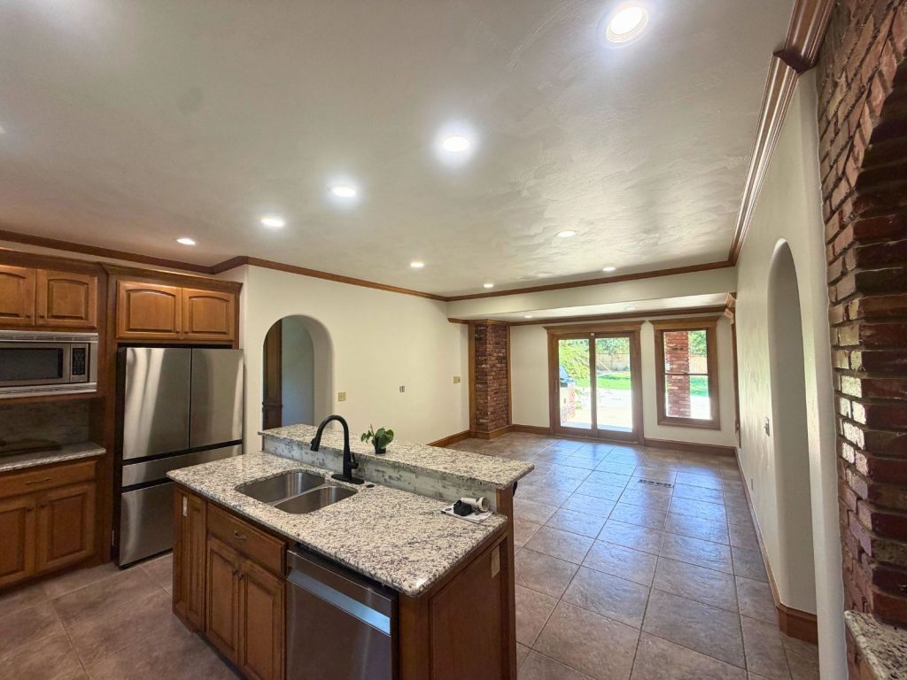 Open-concept home interior with a kitchen, dining area and freshly painted walls