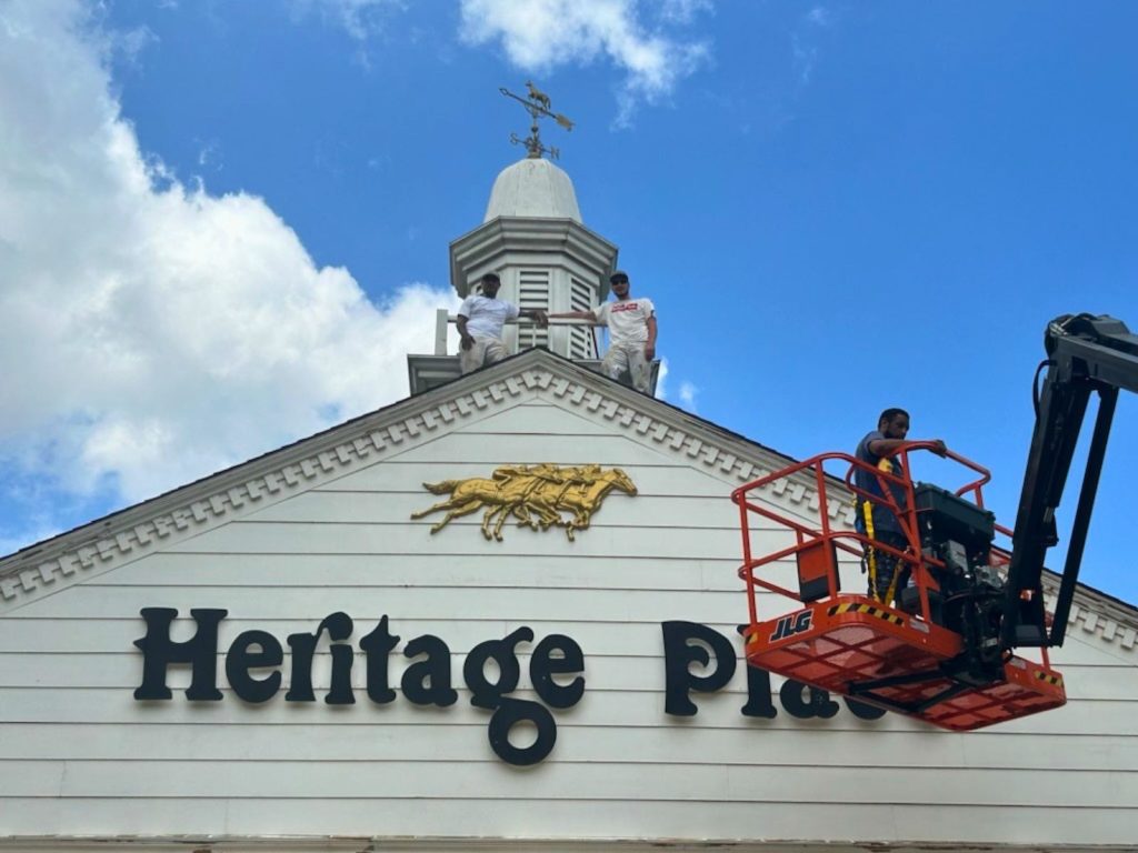 Painters working from a lift on the exterior of a commercial building